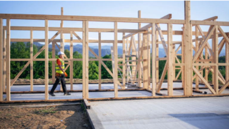 Contractor walking through a wooden structure
