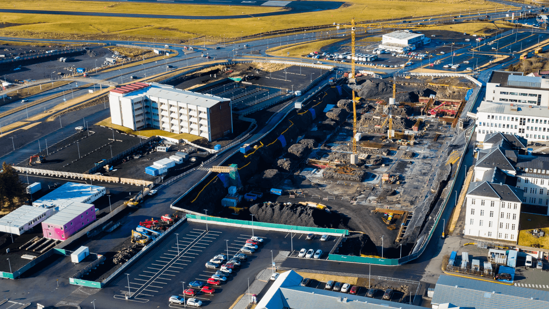 Aerial shot of a construction site and the buildings next to it