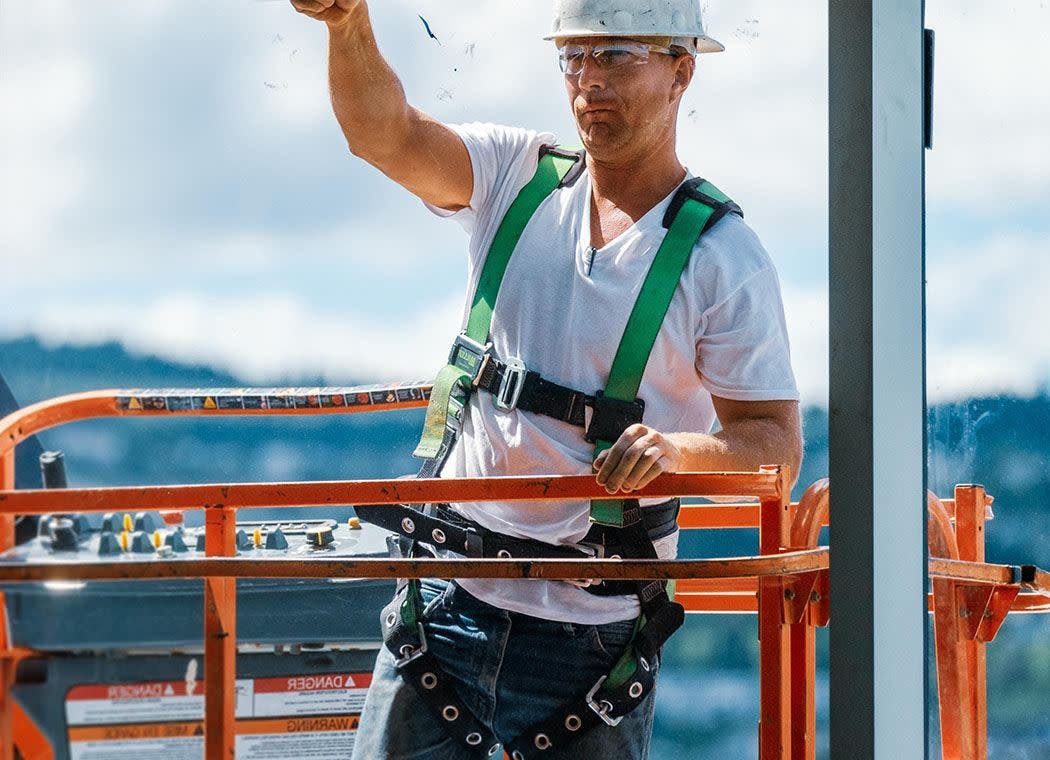 Construction worker on a lift on site