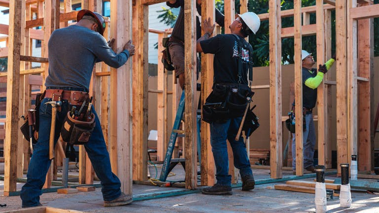 Contractors placing wood walls