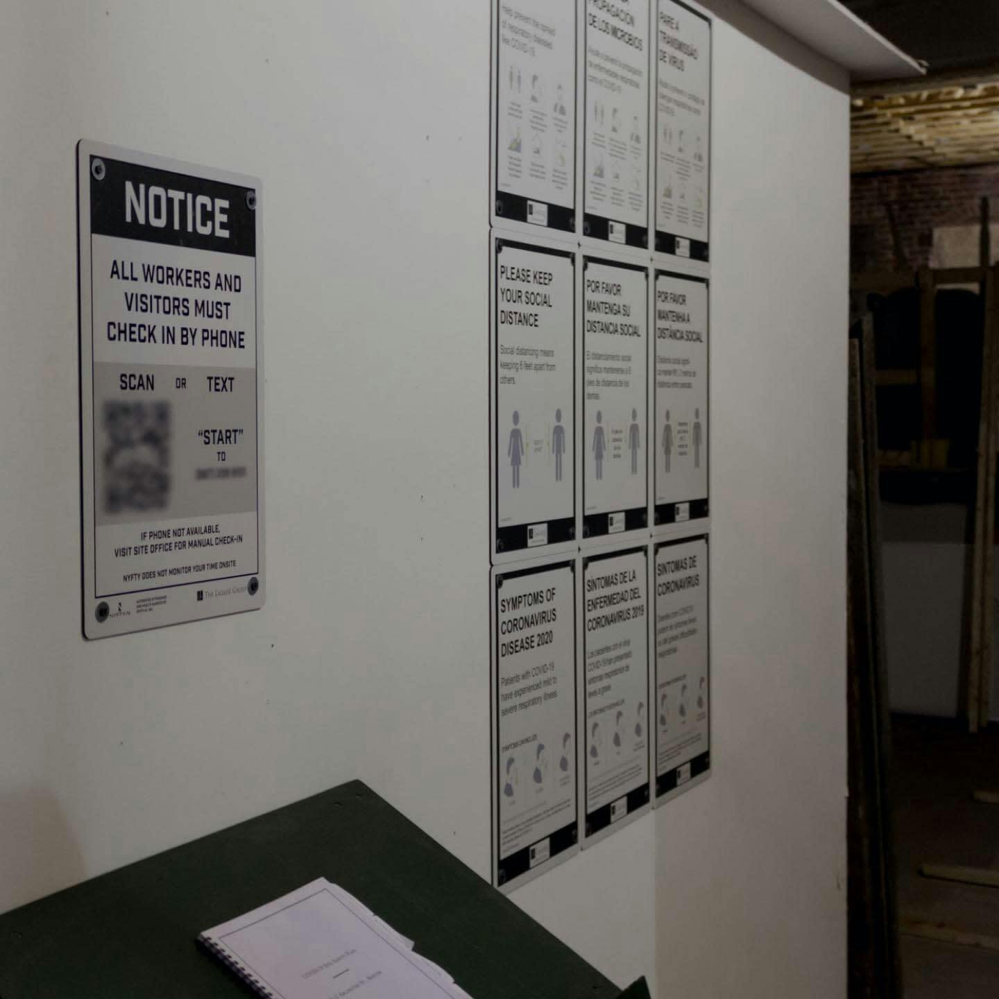 Posted COVID-19 safety signs in construction office