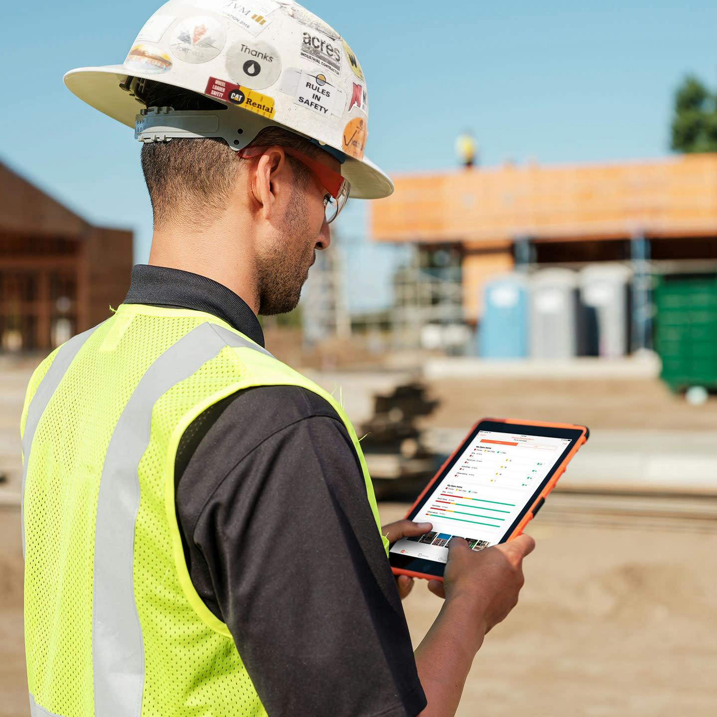 Contractor using Procore's software on site