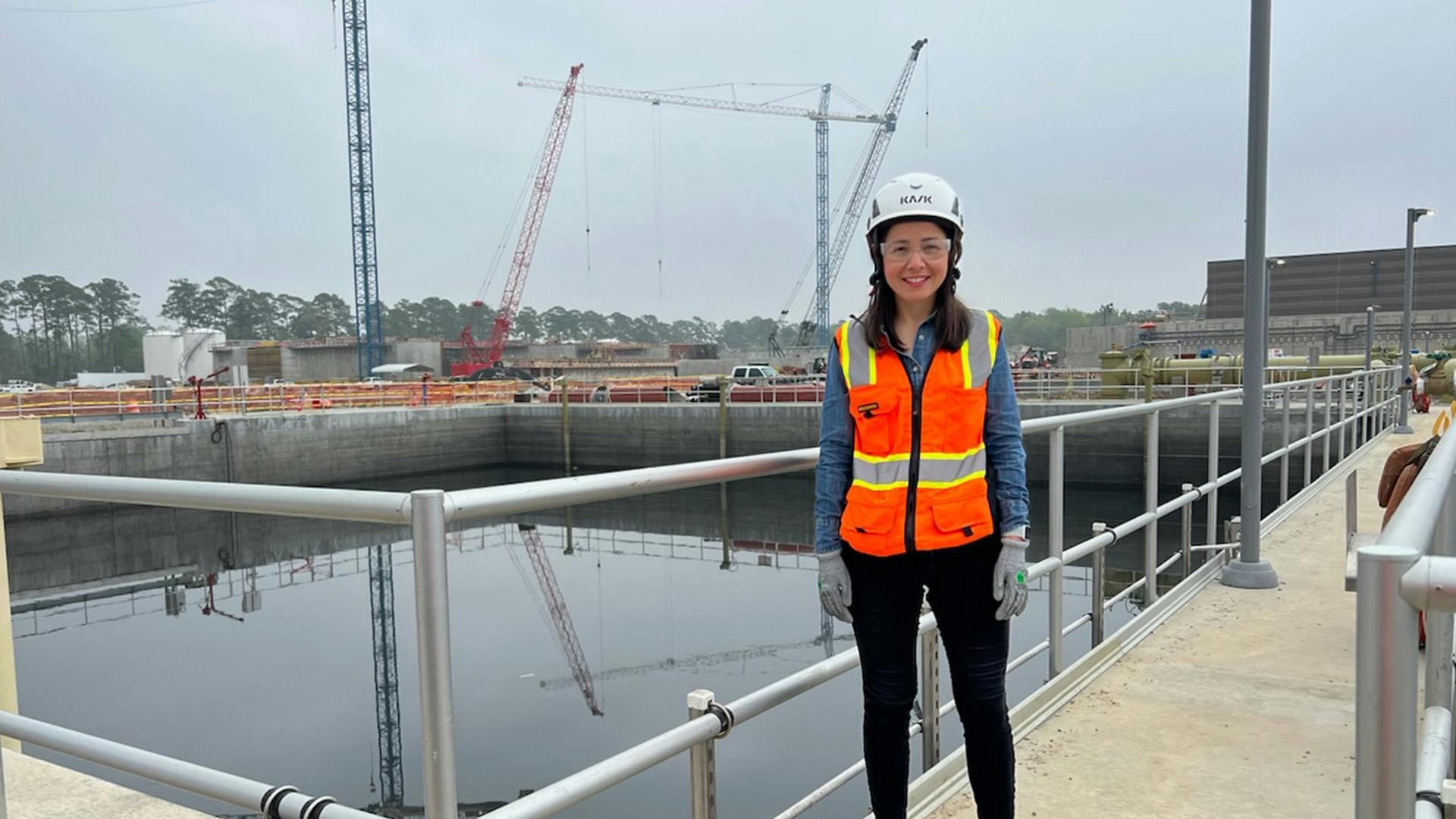 Indra Gutierrez standing on a construction site smiling to the camera