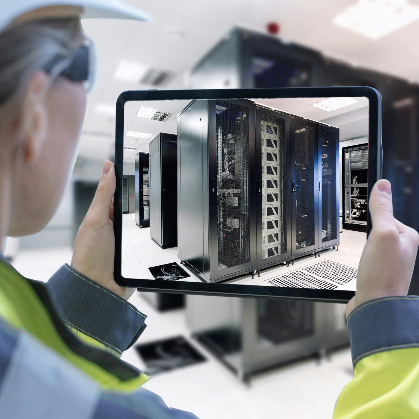 Woman taking a picture of a data center's servers with a tablet