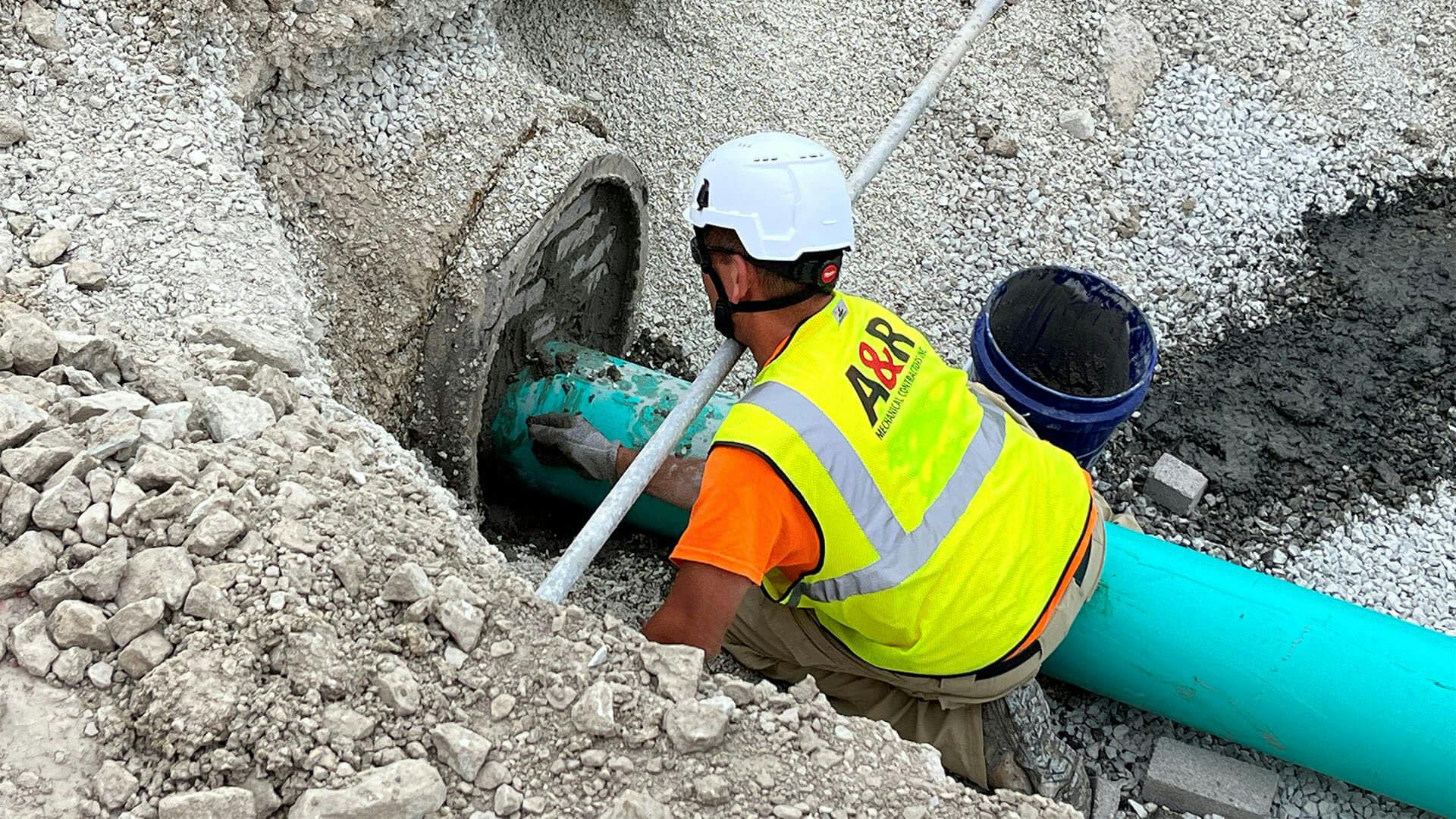 A&R Services worker fixing a pipe
