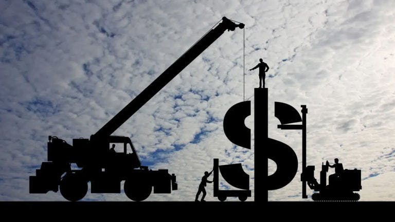Image of construction workers building a dollar sign using machinery