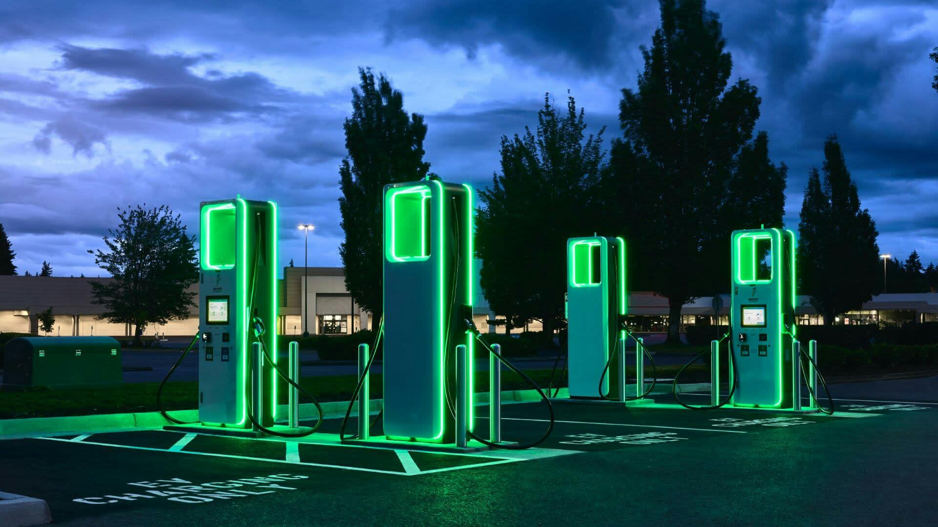 Finished project where electric car charges were installed, now fully illuminated at dusk