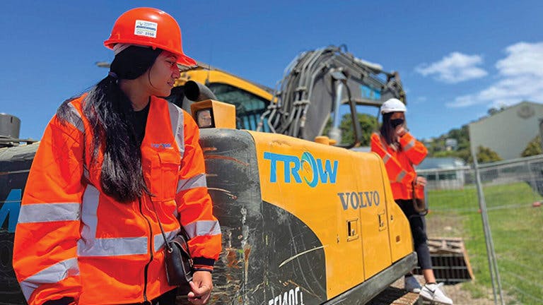 Trow Group construction workers leaning on a machine