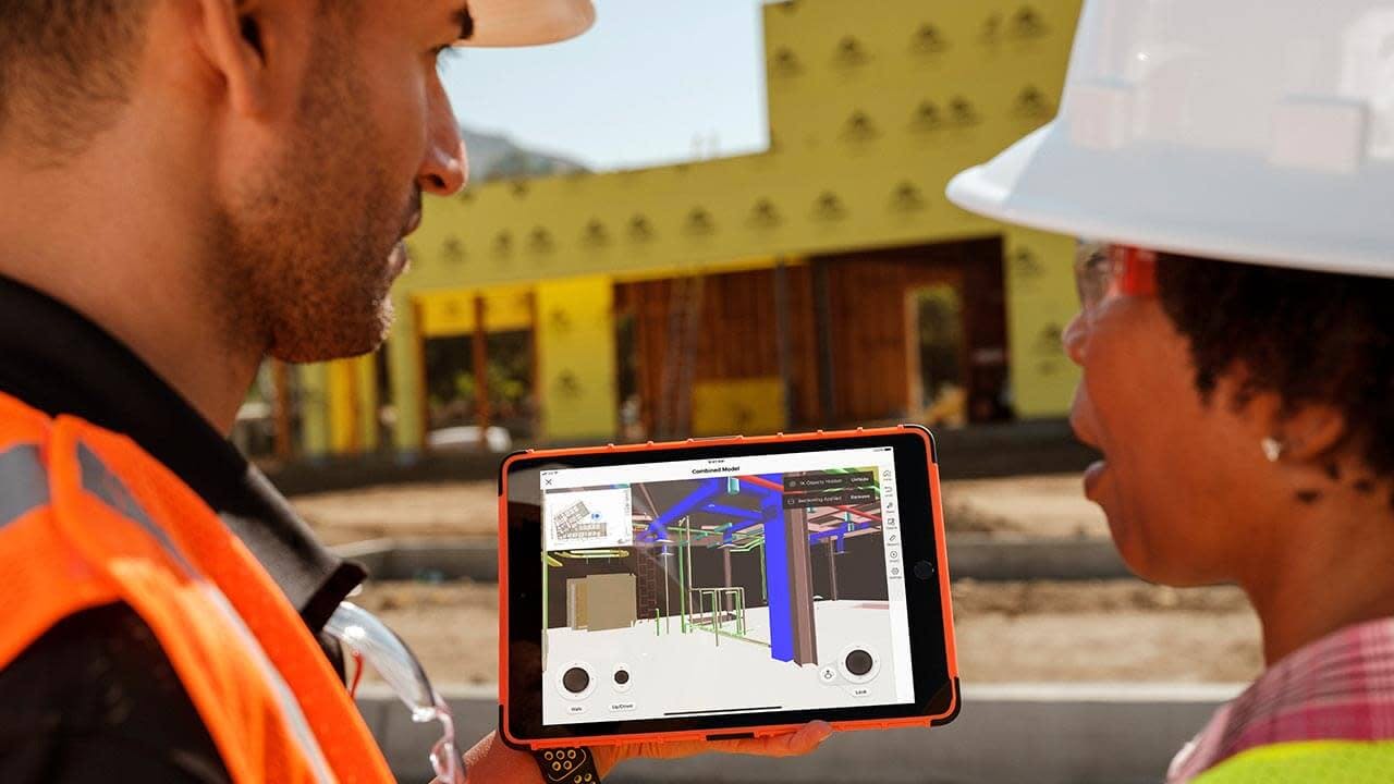 Construction workers uses Procore BIM on a jobsite