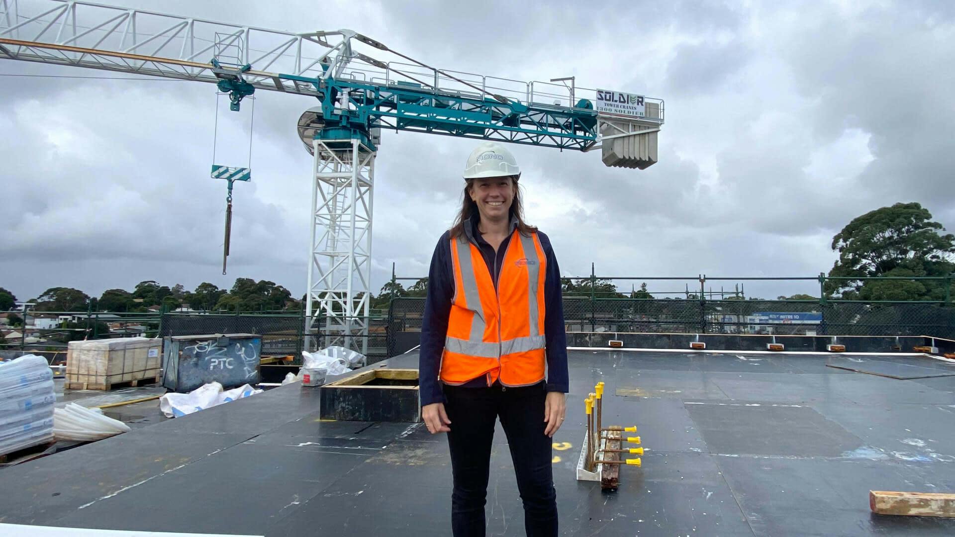 Michelle Stack standing on a site in front of a crane