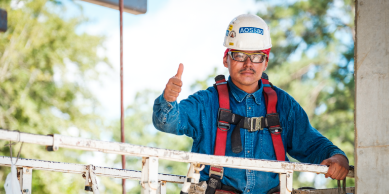 Photo of contractor in PPE and harness giving a thumbs up to proceed