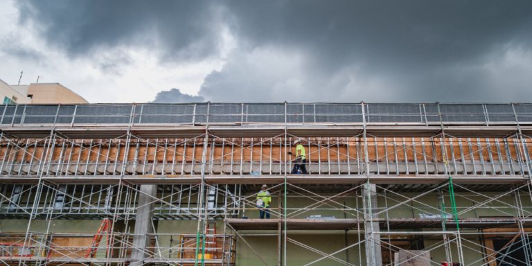 Photo of a building under construction covered in scaffolding