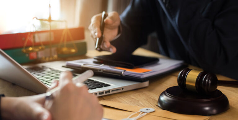 Photo of two people discussing a contract in a law office