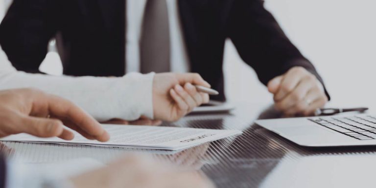 Two people review financial documents.