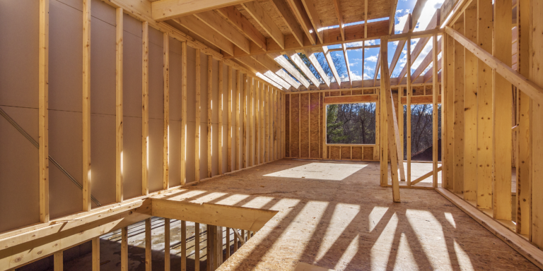 Photo of the incomplete inside of a structure with exposed wood framing