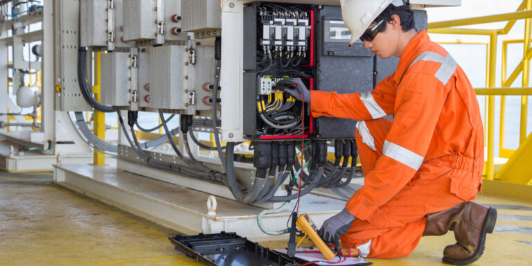 An electrical contractor tests voltage on a commercial distribution system.