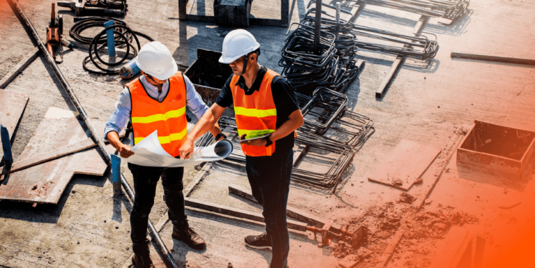 A construction manager talking to another construction worker on a jobsite