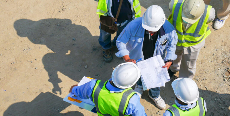 Construction workers collaborating at meeting site