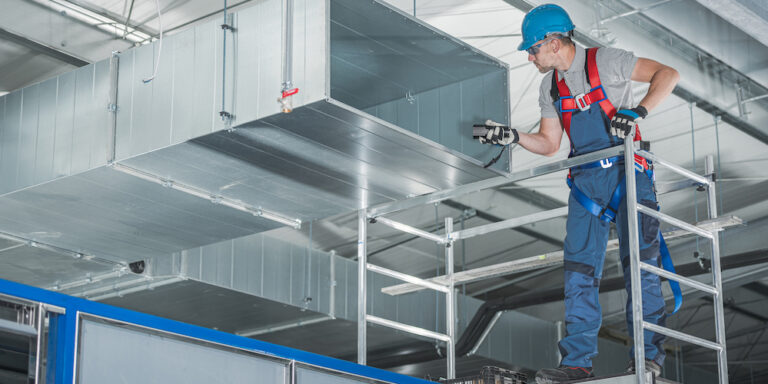 HVAC mechanical contractor testing newly installed warehouse ventilation system