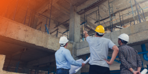 Workers conducting construction project management tasks on a jobsite