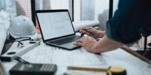 Photo of general ledger on a laptop with someone working