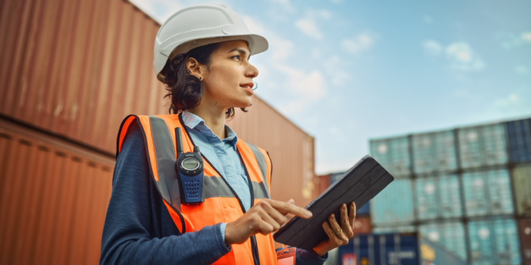 A construction enginereer on a jobsite holding a tablet