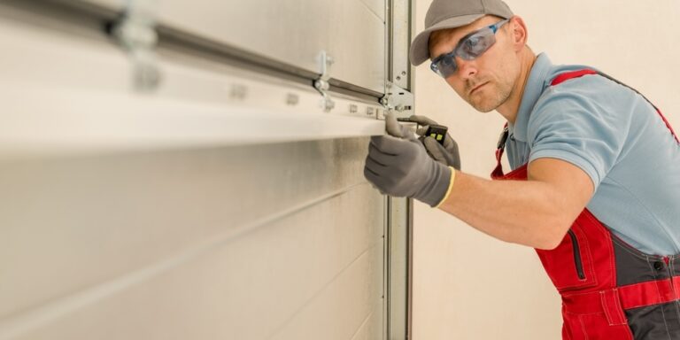 Man checking the level of a metal beam on a door.