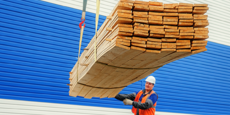 Photo of construction worker helping move materials
