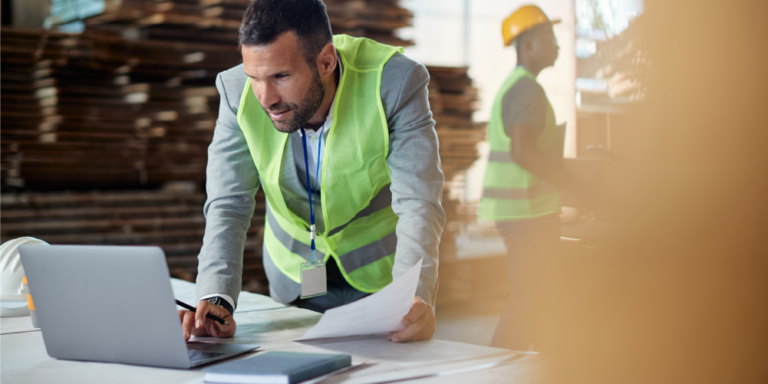 Photo of construction professional examining accounting paperwork