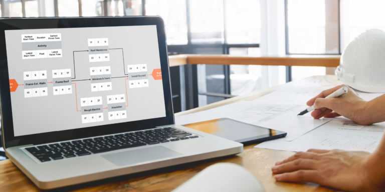 Laptop displaying a planning chart for the critical path method in construction on the screen