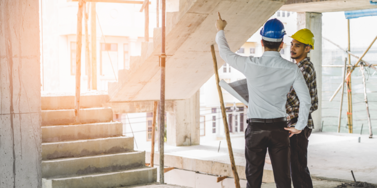 Photo of two construction professionals surveying a jobsite