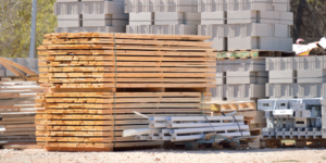 Stacked wood pallets and cinder blocks sitting on a construction site.