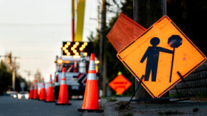 Traffic control plan signs and cones redirecting traffic in a construction site zone