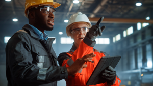 Subcontractors on a jobsite looking at data on a tablet