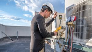 Professional HVAC technician taking an amperage reading on a mini-split ductless air conditioning system.