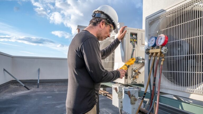 Professional HVAC technician taking an amperage reading on a mini-split ductless air conditioning system.