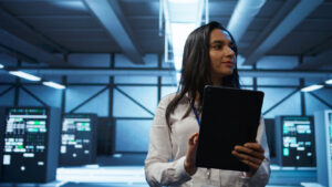 Woman inspecting data center server room