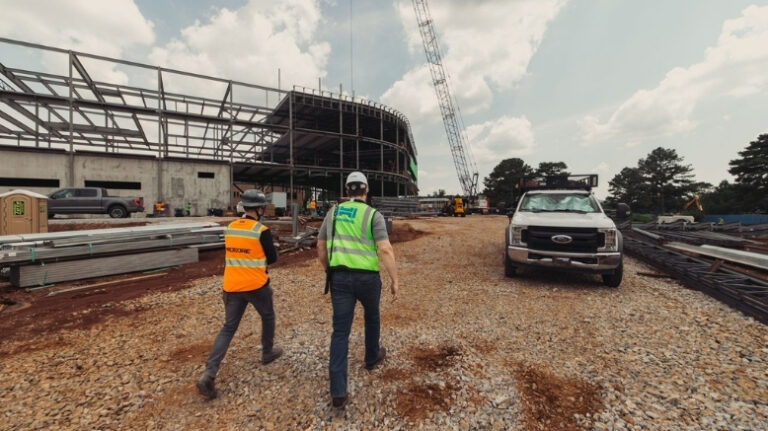2 construction contractors walking a jobsite