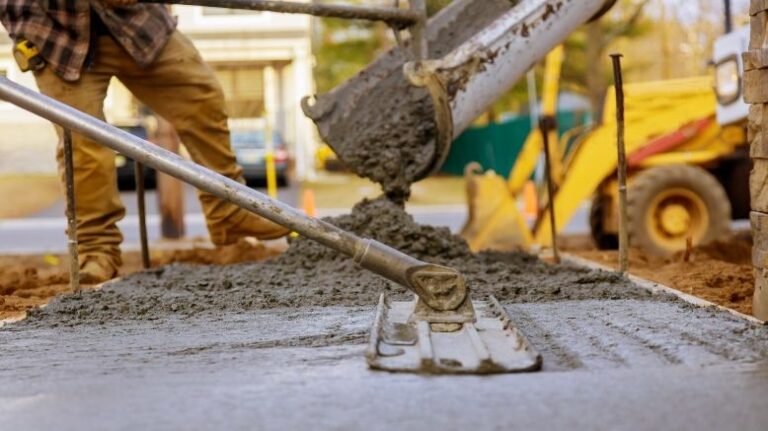 Concerete being poured and smoothed on a construction site
