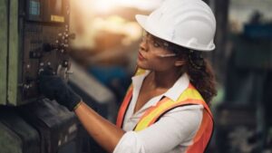 Photo of a female construction worker in a vest and hard hat on a jobsite