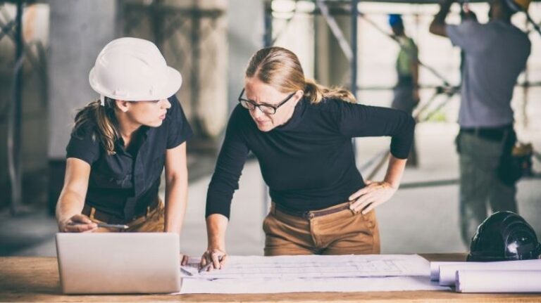 Marketing professional talking to construction professional in a hard hat