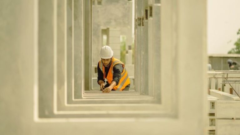 Worker measuring window frames on a jobsite