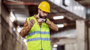 construction worker talking into smartwatch
