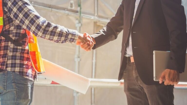Two builders shaking hands