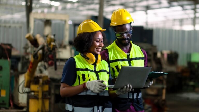 Two workers looking at data on a tablet