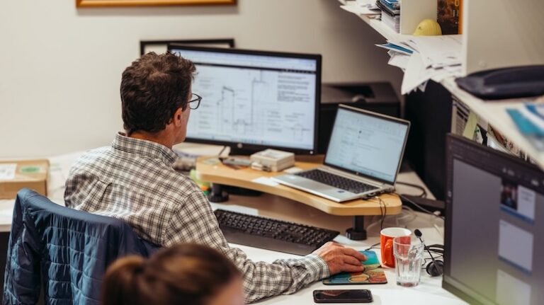 Construction document management software desktop computers in an office