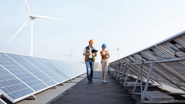 Two workers inspecting solar panels