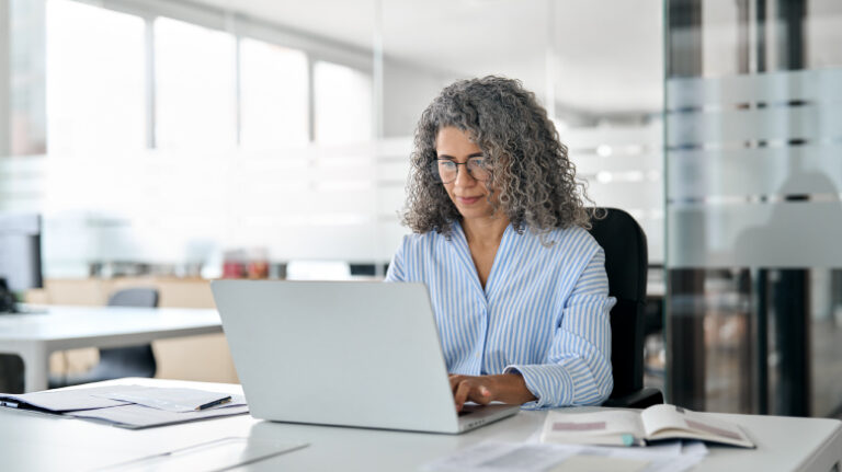 Woman at construction owner firm at a laptop in an office