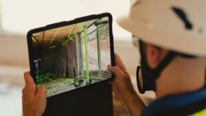 Worker checking a 3D model of a space before an inspection