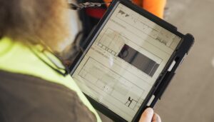 Field worker checking construction dashboard on a tablet